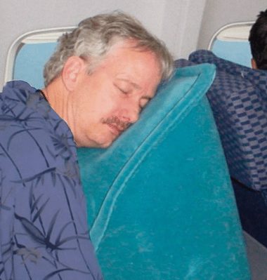 how to sleep on a plane skyrest pillow