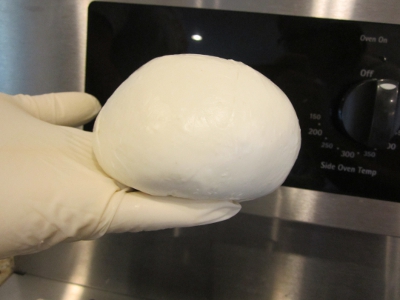 DIY - Mozzarella cheese - Form a tight cheese ball with the flat of your palm and press your fingers upward on the bottom middle of the cheese mass.