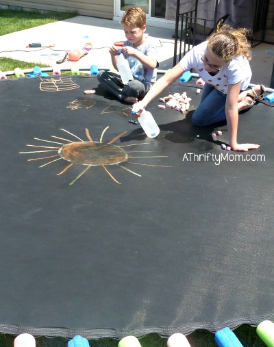 drawing on the trampoline with sidewalk chalk, #thriftysummerfun, #keepingkidsentertained, #summerfun, #chalk, #summer, #sidewalkchalk